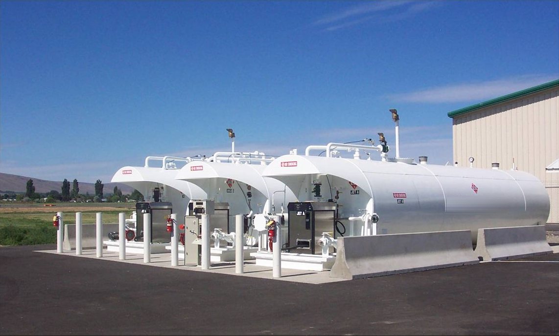 Aboveground Jet A tanks with dispensers, bollards and barriers at an airport fuel farm
